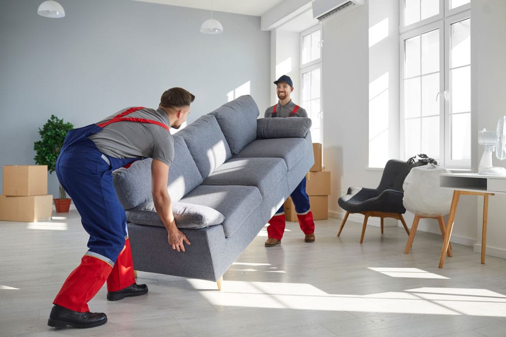 Men Moving A Sofa